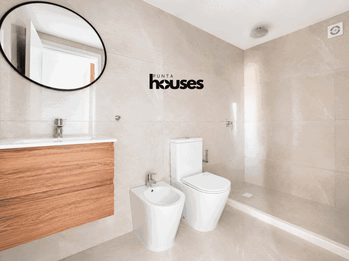Modern bathroom with walk-in shower and wood vanity in new apartment for sale in Punta del Este.