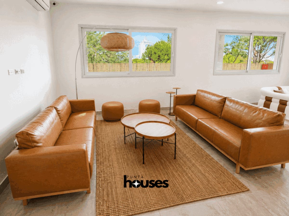 Refined communal lounge with floor-to-ceiling windows, marble finishes and comfortable seating for residents and guests.