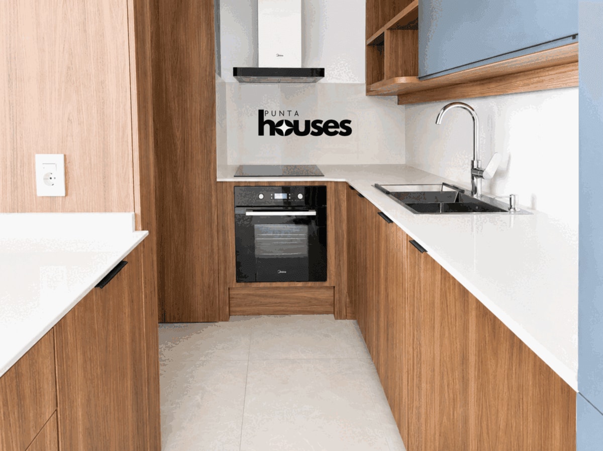 Modern integrated kitchen with wood cabinets in brand-new apartment near Playa Brava Punta del Este.