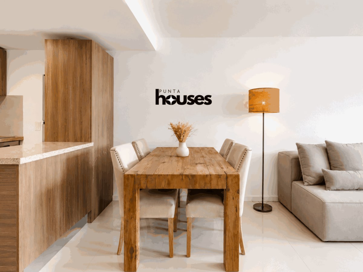 Furnished dining area beside integrated kitchen in Gala Vista one-bedroom apartment for sale in Punta del Este.