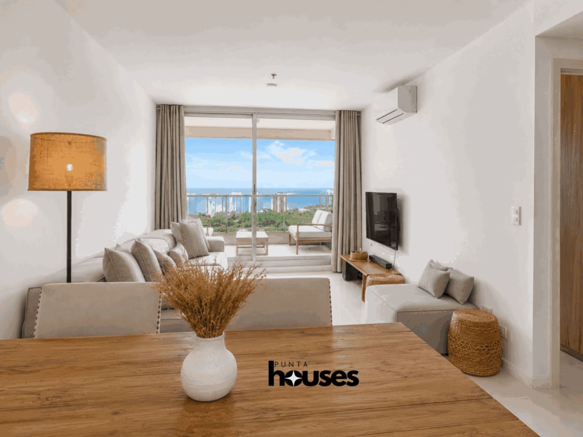 Open-plan living and dining room with integrated kitchen in furnished Gala Vista apartment in Punta del Este.