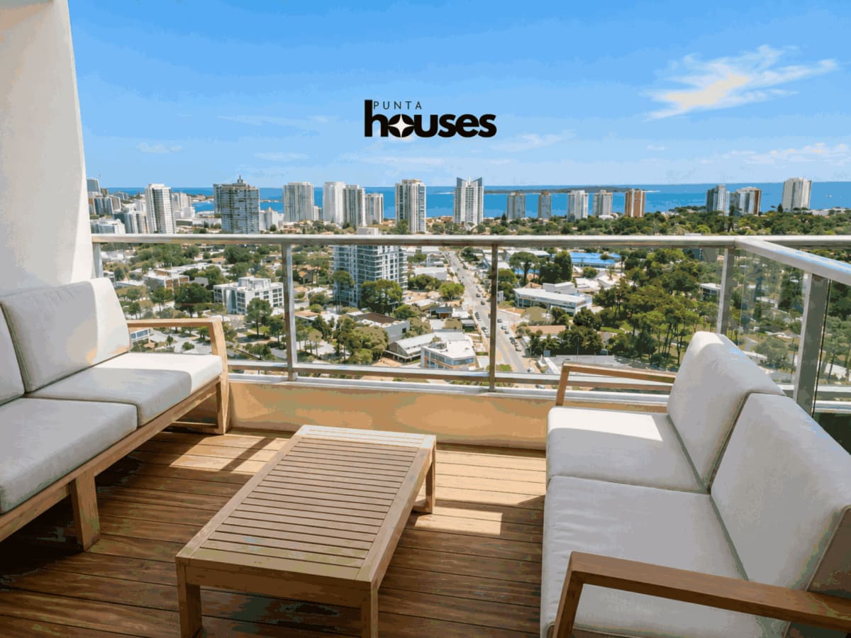 Modern living room with large balcony doors and ocean views in one-bedroom Gala Vista apartment near Playa Mansa.