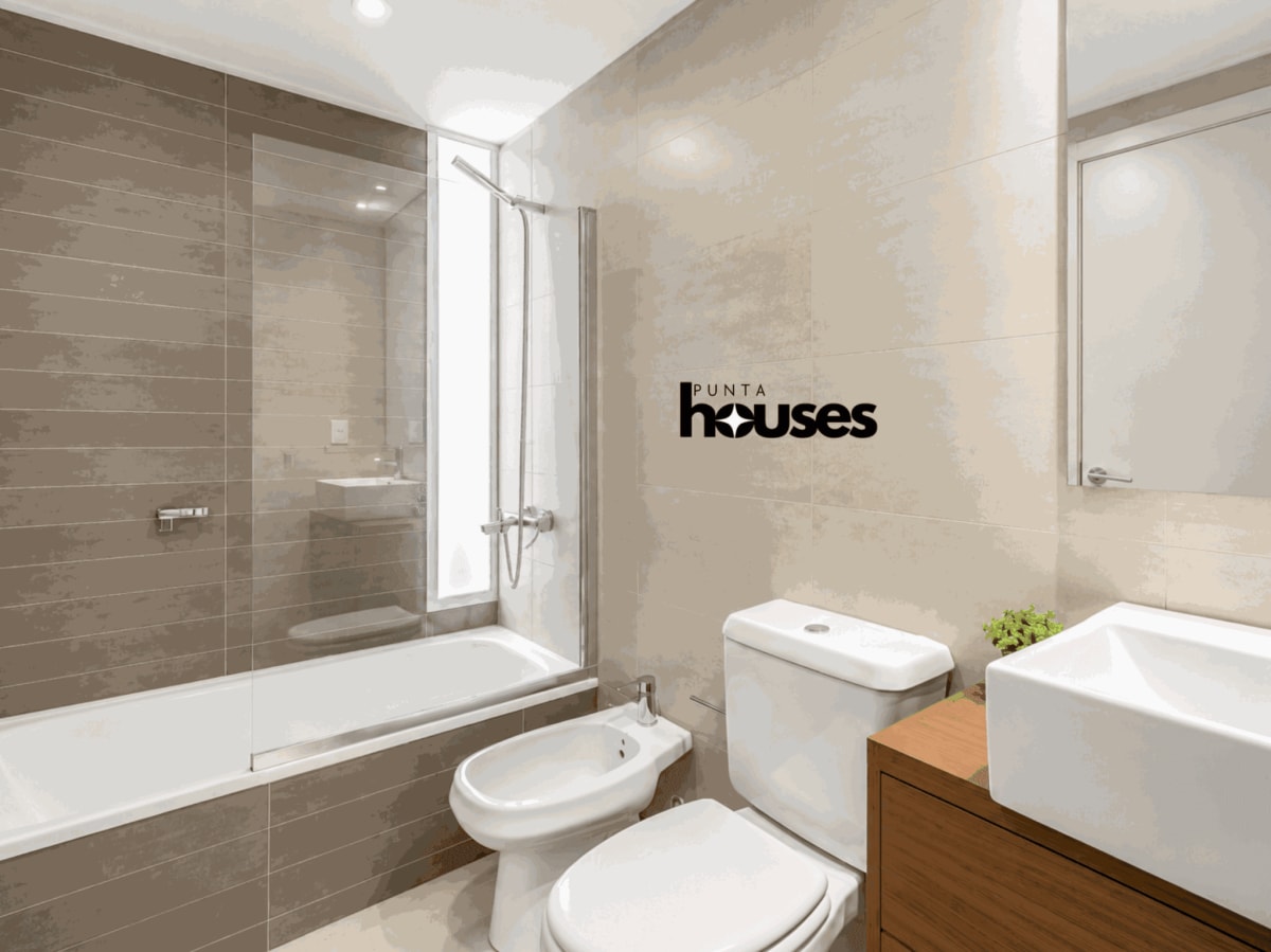 Modern bathroom with bathtub, shower screen, bidet and wood vanity in one-bedroom Gala Vista apartment.