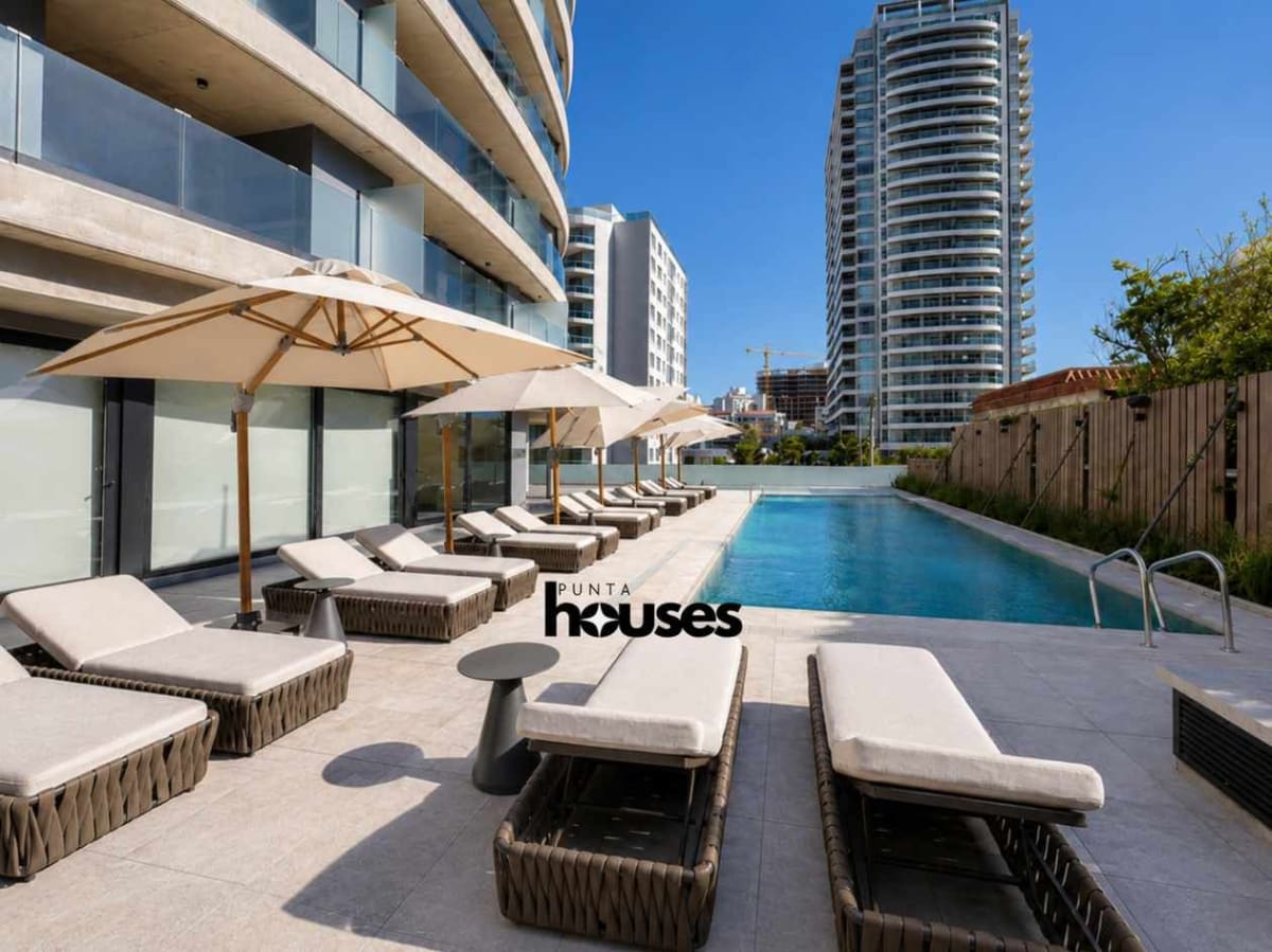 Rooftop solarium with loungers and panoramic terrace at Manglar Brava residential building Punta del Este.