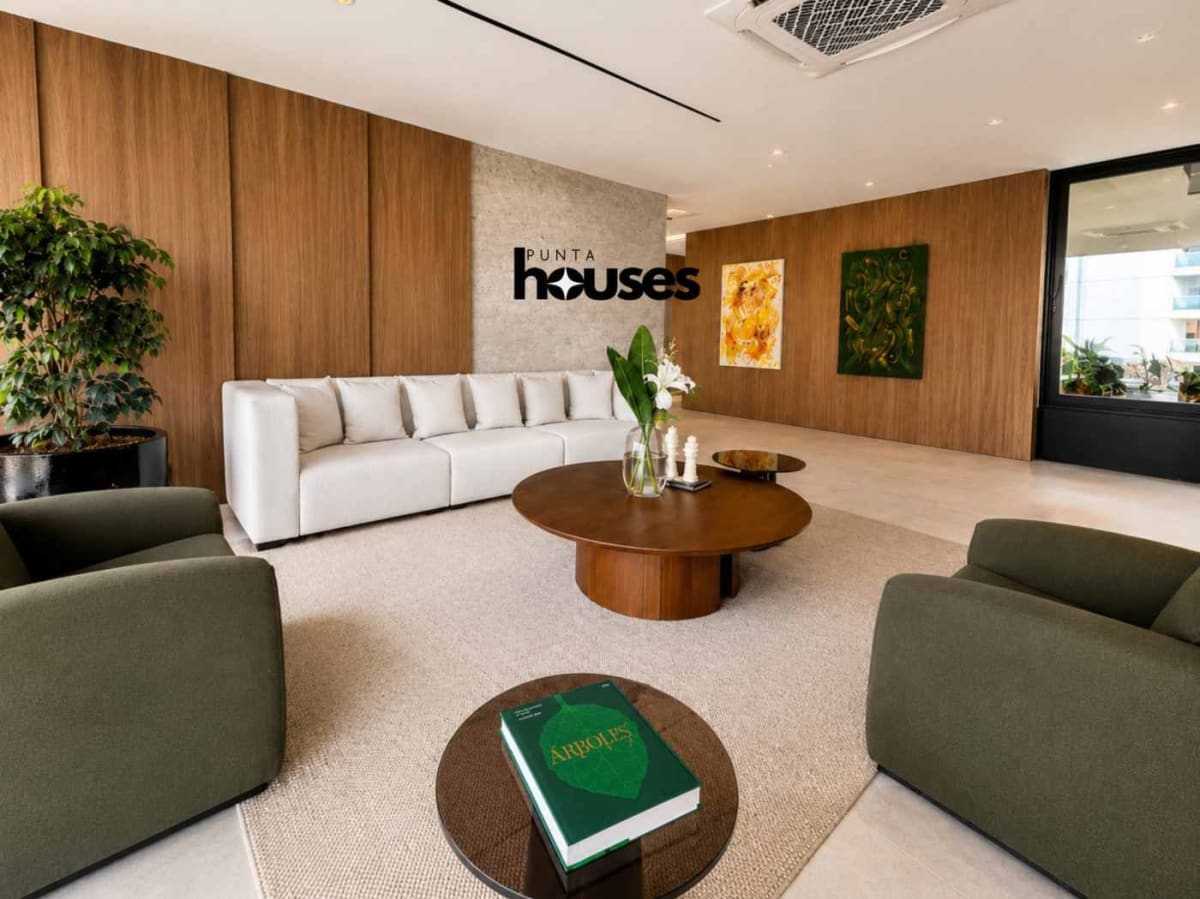 Bright furnished living room with dining area and modern open kitchen in Manglar Brava apartment near Playa Brava.
