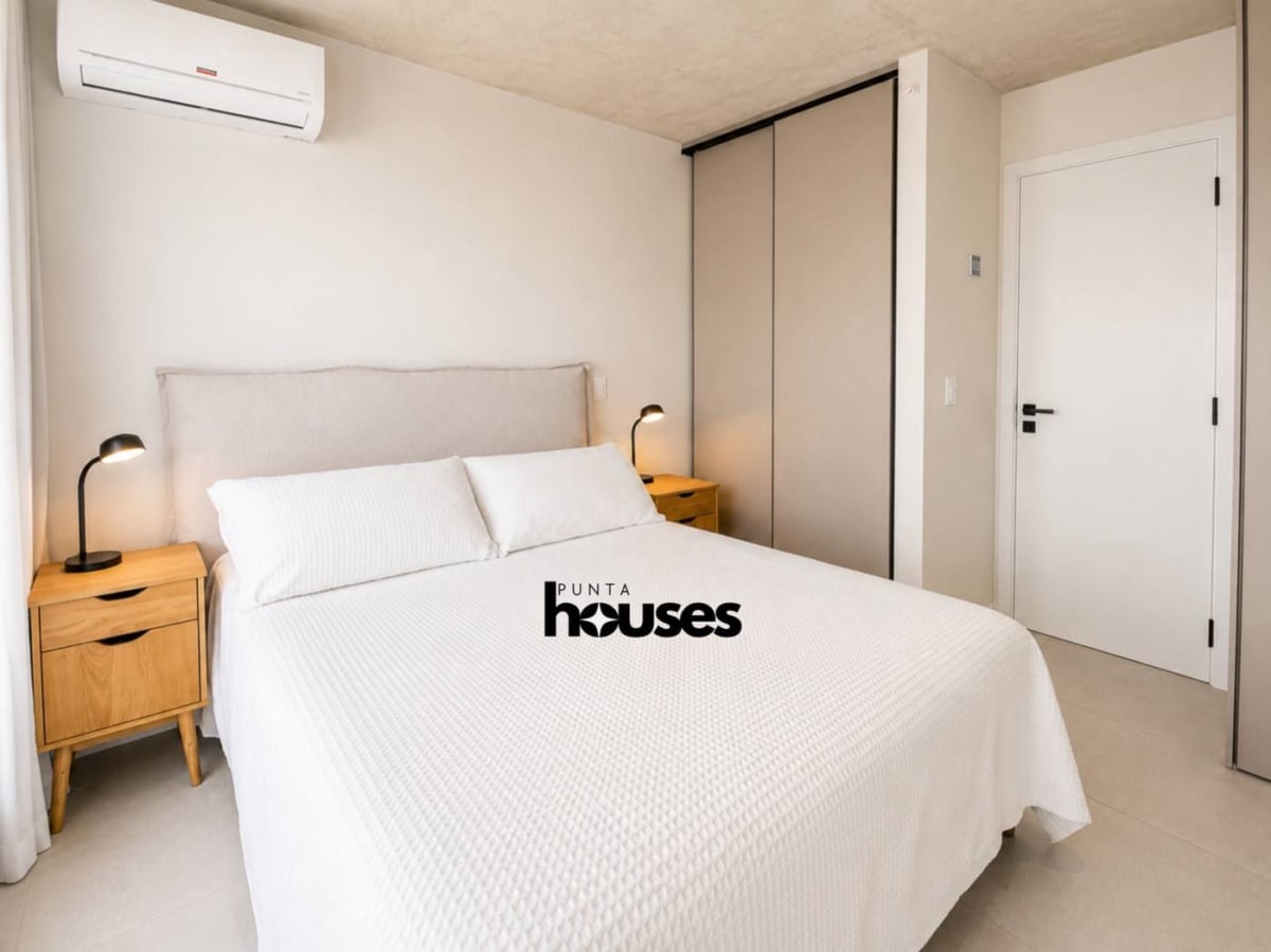 Modern bedroom with built-in wardrobe and air conditioning in Manglar Brava apartment Punta del Este.
