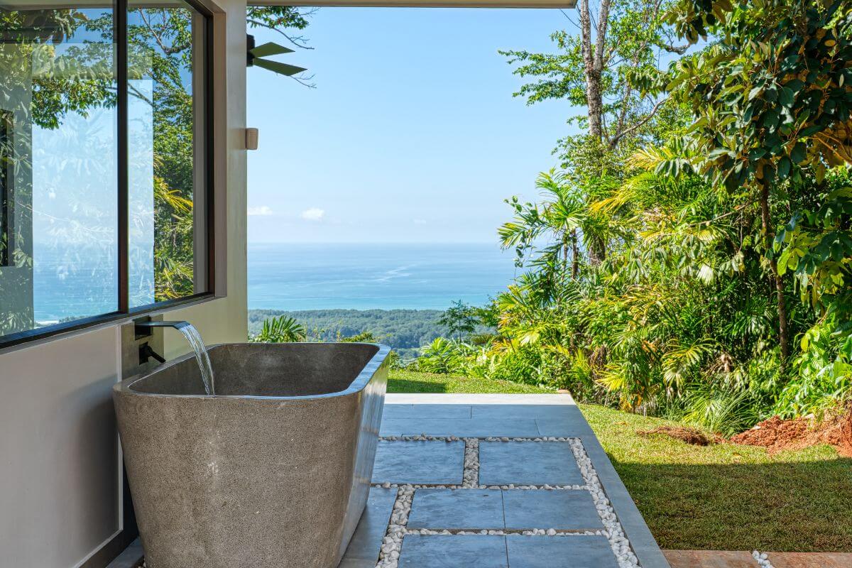 Spa-style bathroom with a large soaking tub and panoramic ocean views at Brisas del Mar in Quepos, Costa Rica.