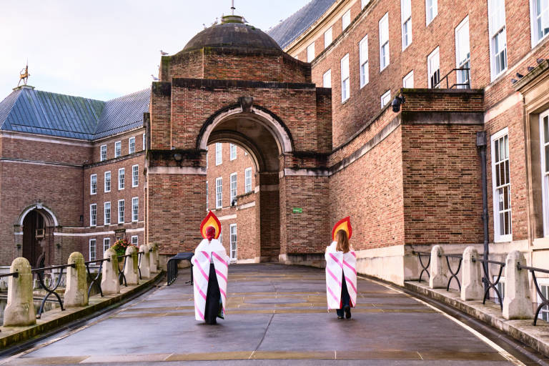 Members of Extinction Rebellion dressed as birthday candles deliver a card and a cake to Bristol City Council to celebrate the second anniversary of their declaration of a Climate Emergency. Bristol, November 2020. Photograph Copyright &copy; Simon Holliday