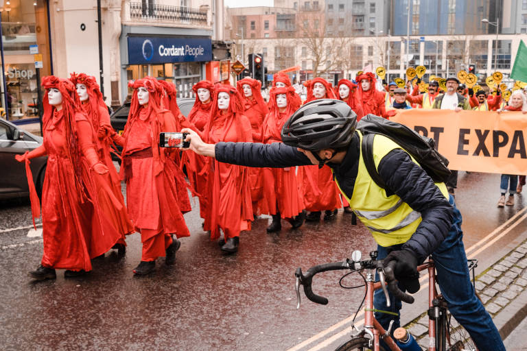 Red Rebel Brigade at a protest against the expansion of Bristol Airport, Bristol, January 2020. Photograph Copyright &copy; Simon Holliday