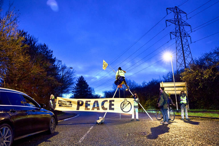 Activists from Extinction Rebellion and Christian Climate Action block roads around the M.o.D in Filton, Bristol, December 11th 2020. Photograph Copyright &copy; Simon Holliday