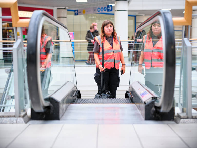 Escalator Faces; The Galleries Shopping Centre, Broadmead, Bristol, August 2024. Photograph Copyright &copy; Simon Holliday