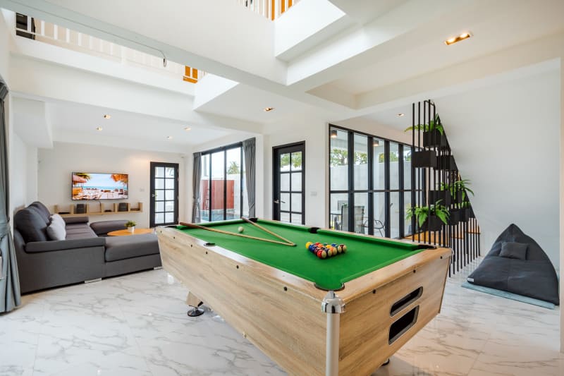 Living room with pool table and lounge at Areeya Retreat villa in Pranburi