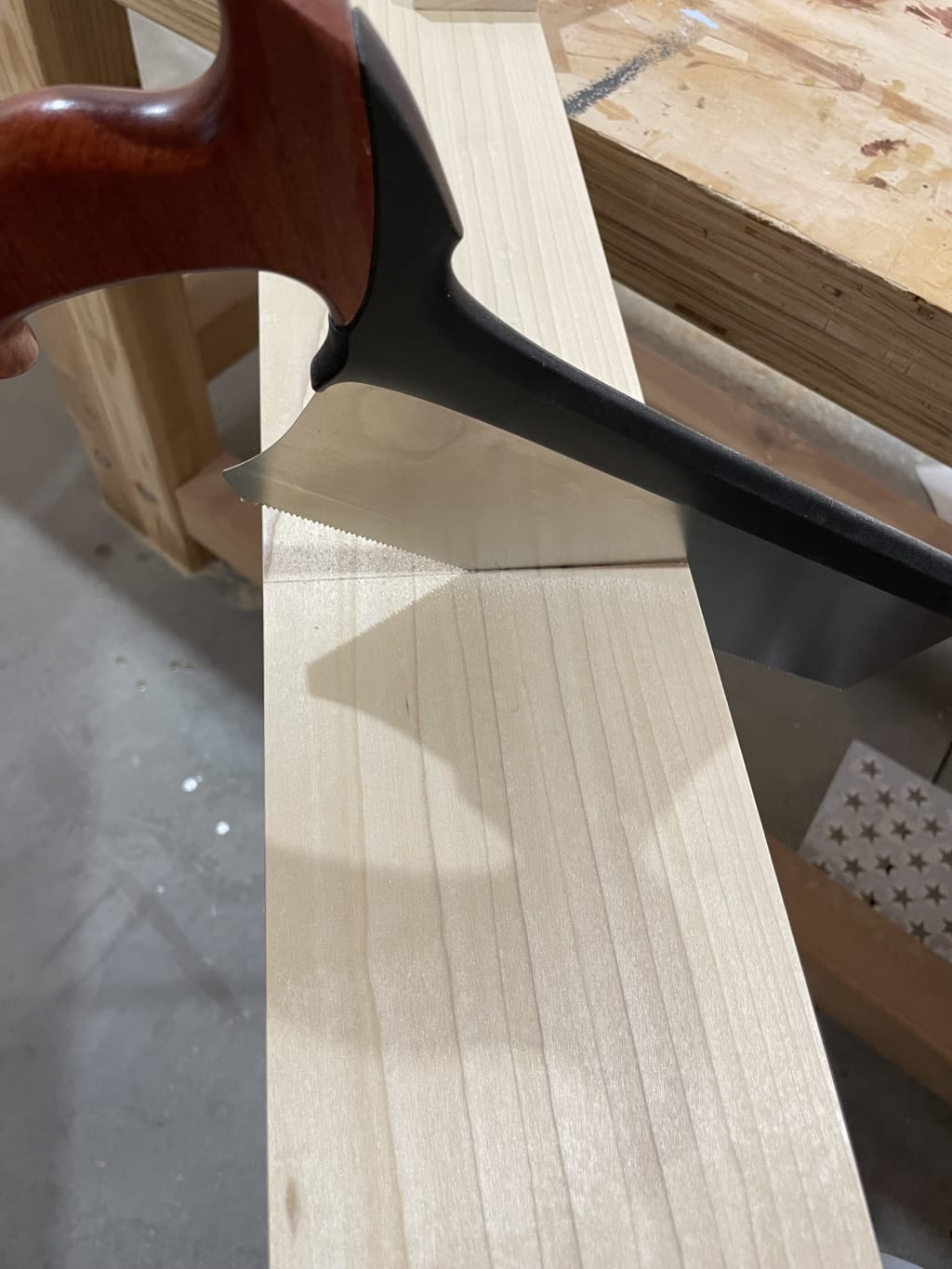 Cutting a board with a handsaw