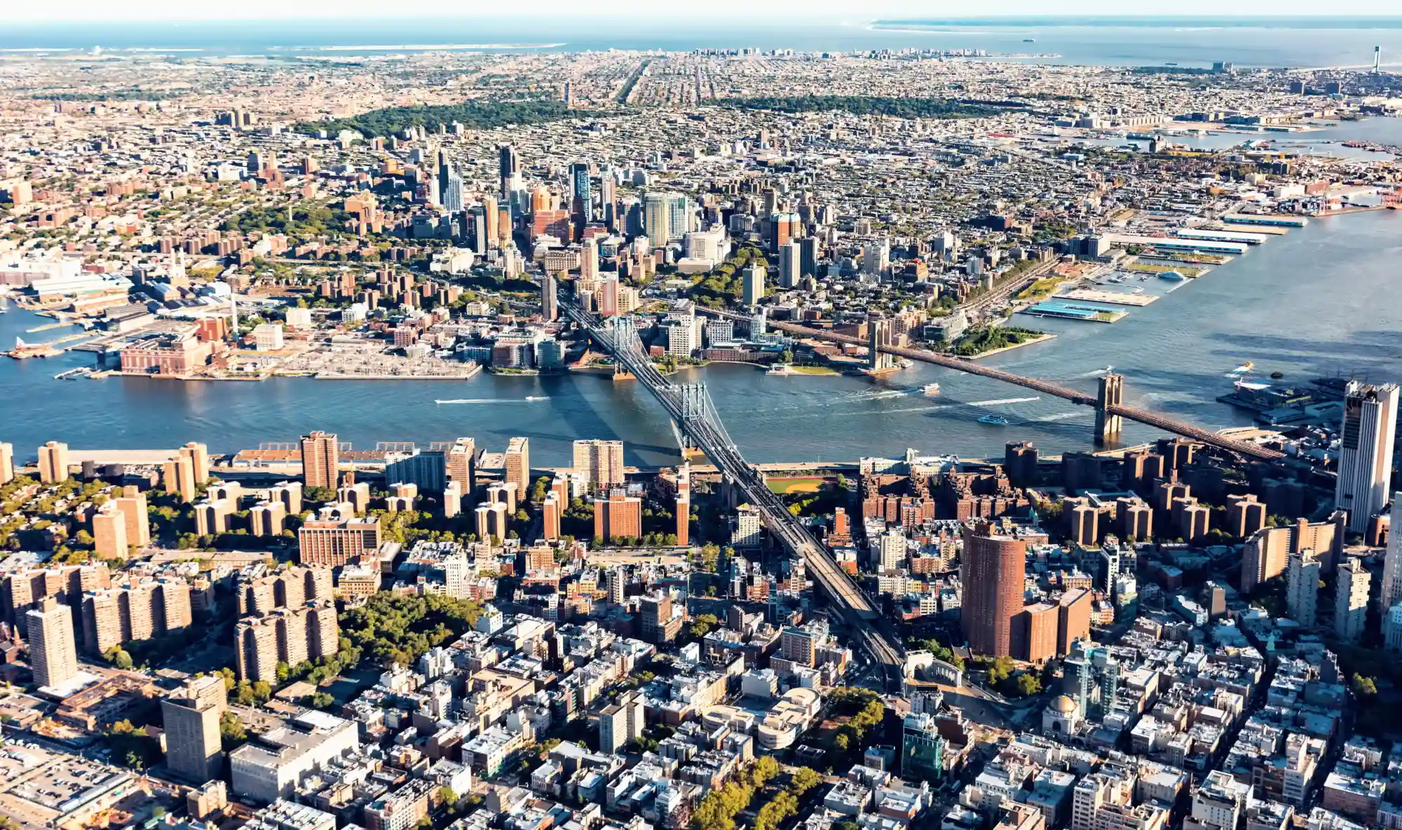 Aerial drone view of Manhattan and Brooklyn neighborhoods from above the East River