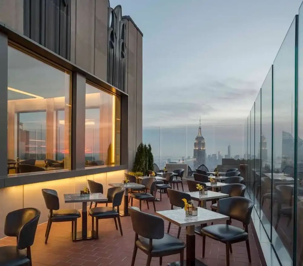 Intimate rooftop bar above Rockefeller Center with a straight view down Fifth Avenue toward Central Park
