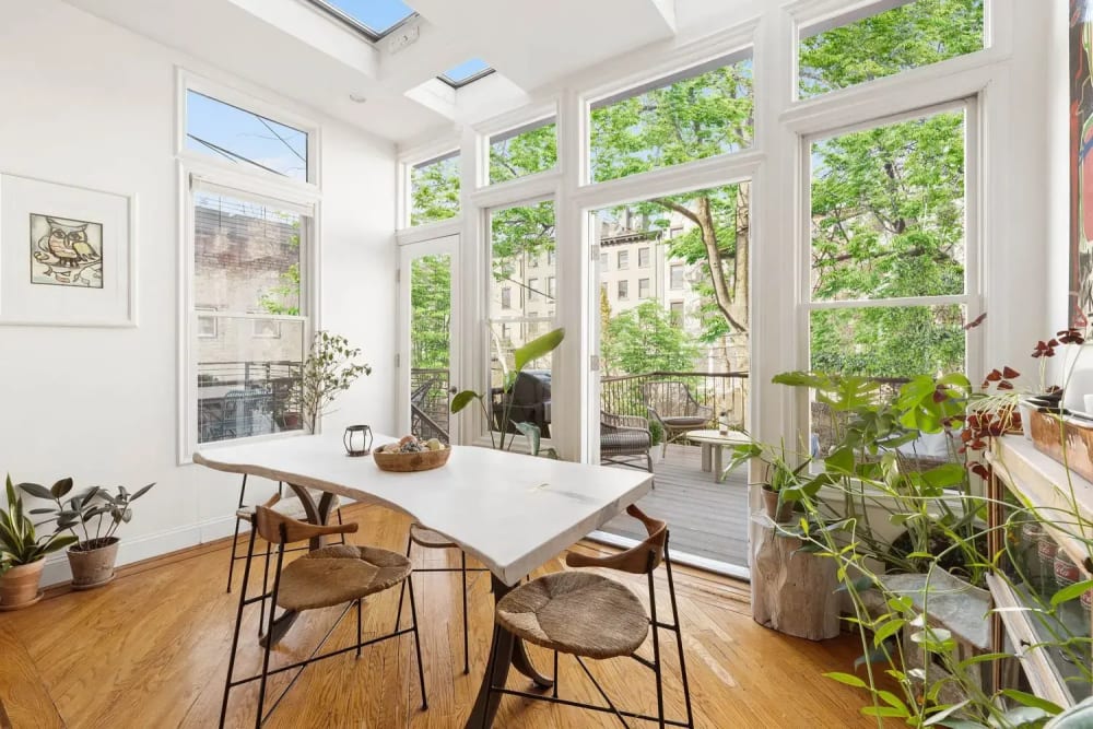 Bright open-plan living room in a luxury Manhattan condo with natural light and modern finishes