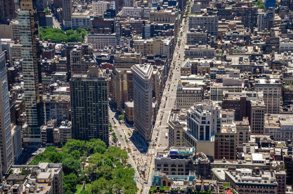 Aerial view of the Flatiron Building and Madison Square Park surrounded by the neighborhood's cast-iron and Beaux-Arts buildings