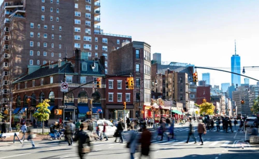 West Village tree-lined street with pedestrians, boutiques, and outdoor cafes