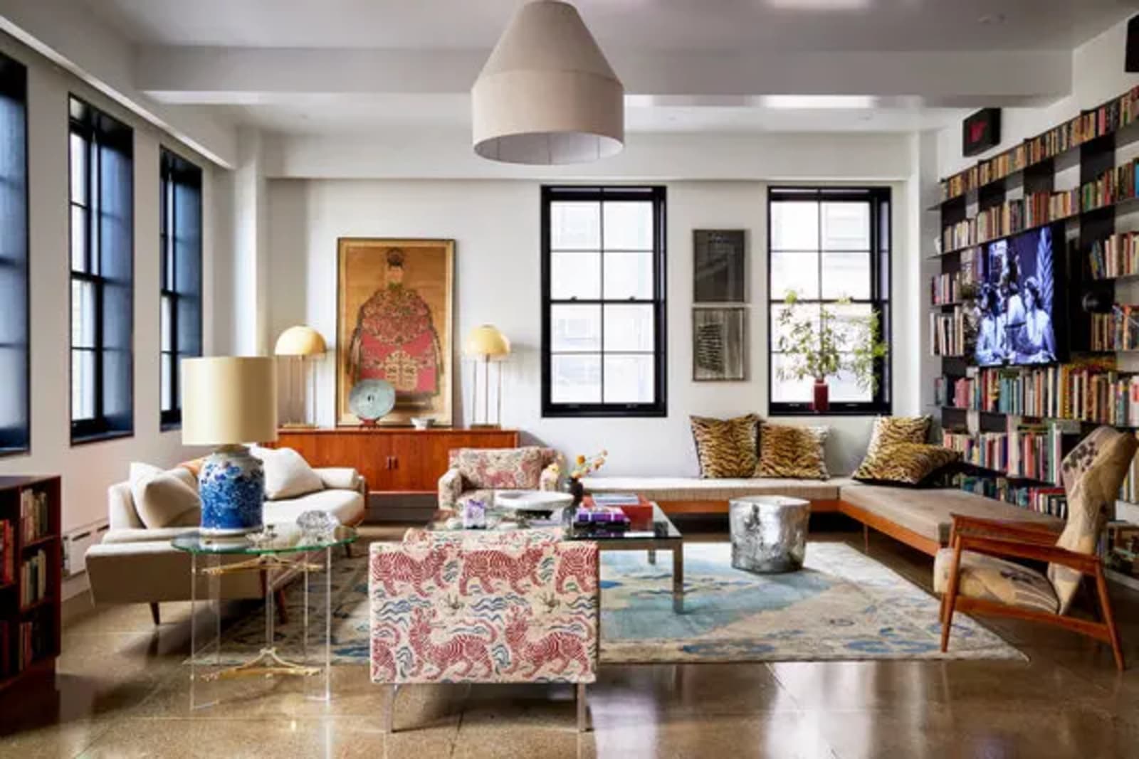 Expansive luxury Manhattan apartment living room with floor-to-ceiling windows overlooking the city skyline