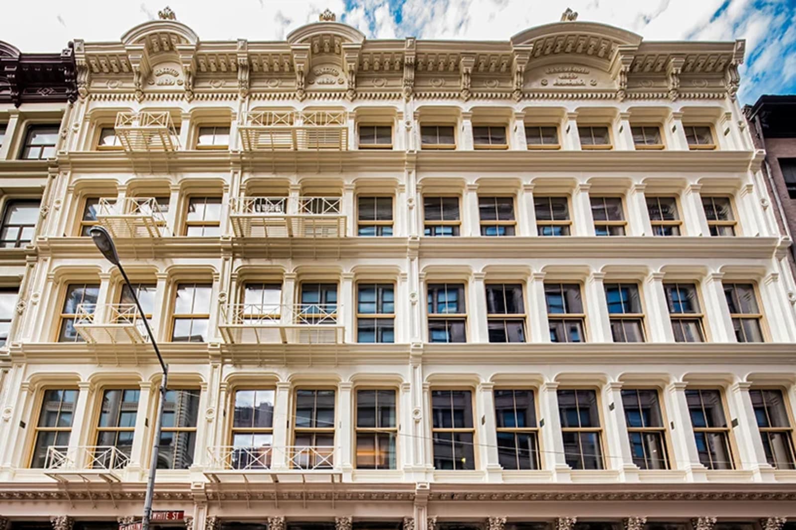 Tribeca building facade with cast-iron architecture on a cobblestone street in downtown Manhattan