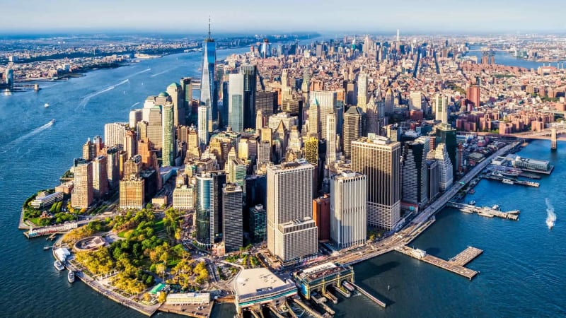 Aerial view of emerging New York City neighborhoods showing skyline and residential streets ideal for real estate investment