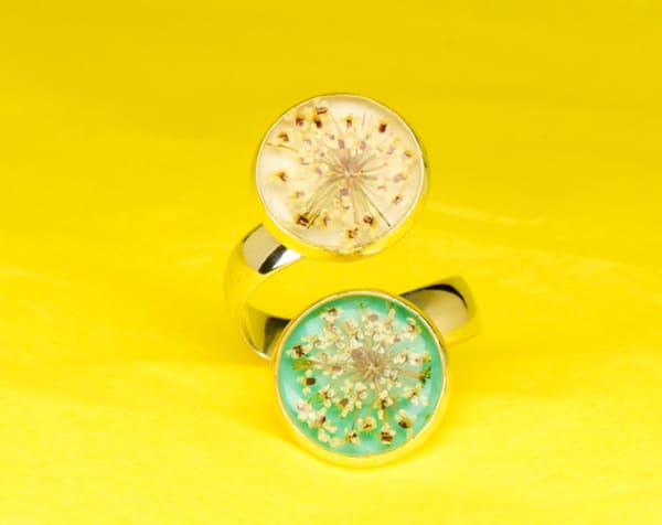 Contrarié ring with wild flowers coated with resin on a light blue and white base