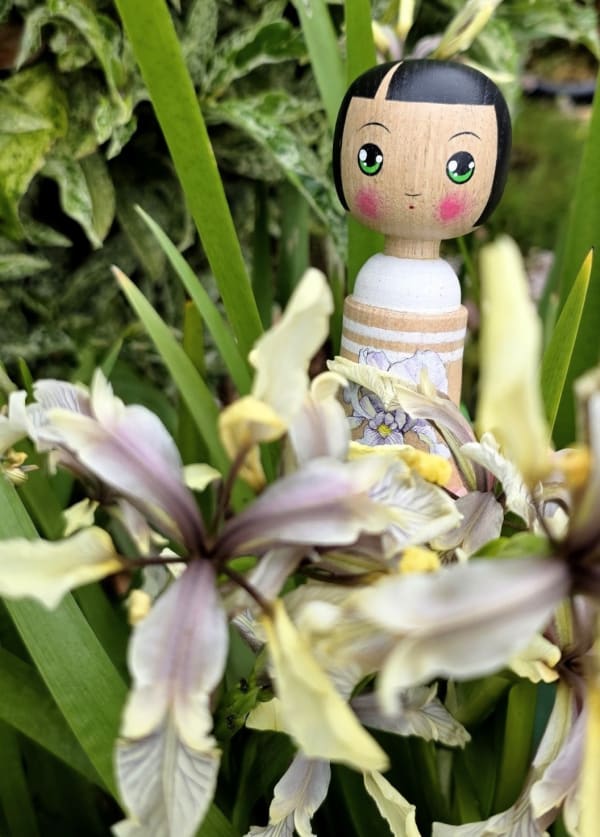 Kokeshi style doll with iris decoration