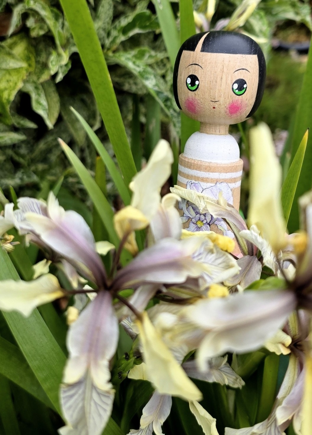 Kokeshi style doll with iris decoration