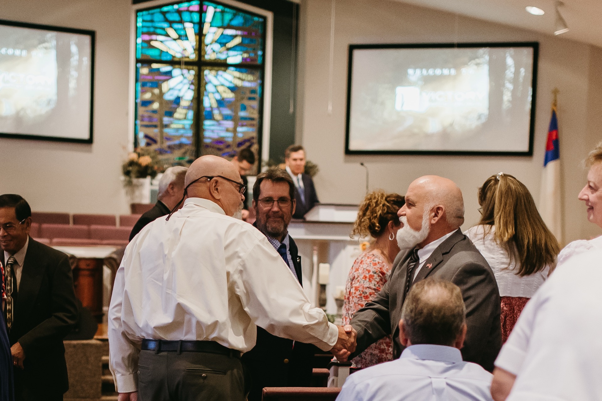 Members greeting in sanctuary