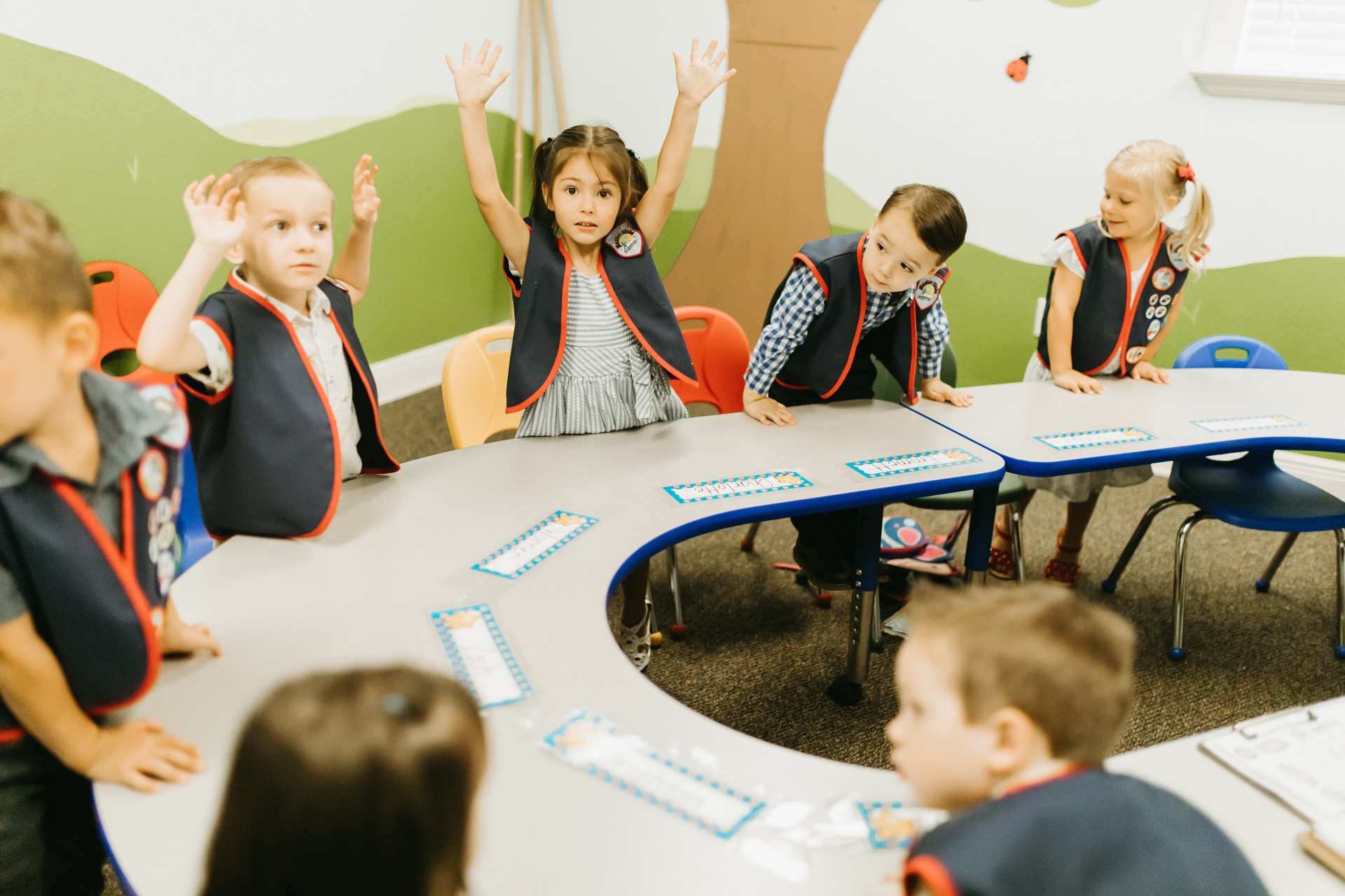 Young children with raised hands