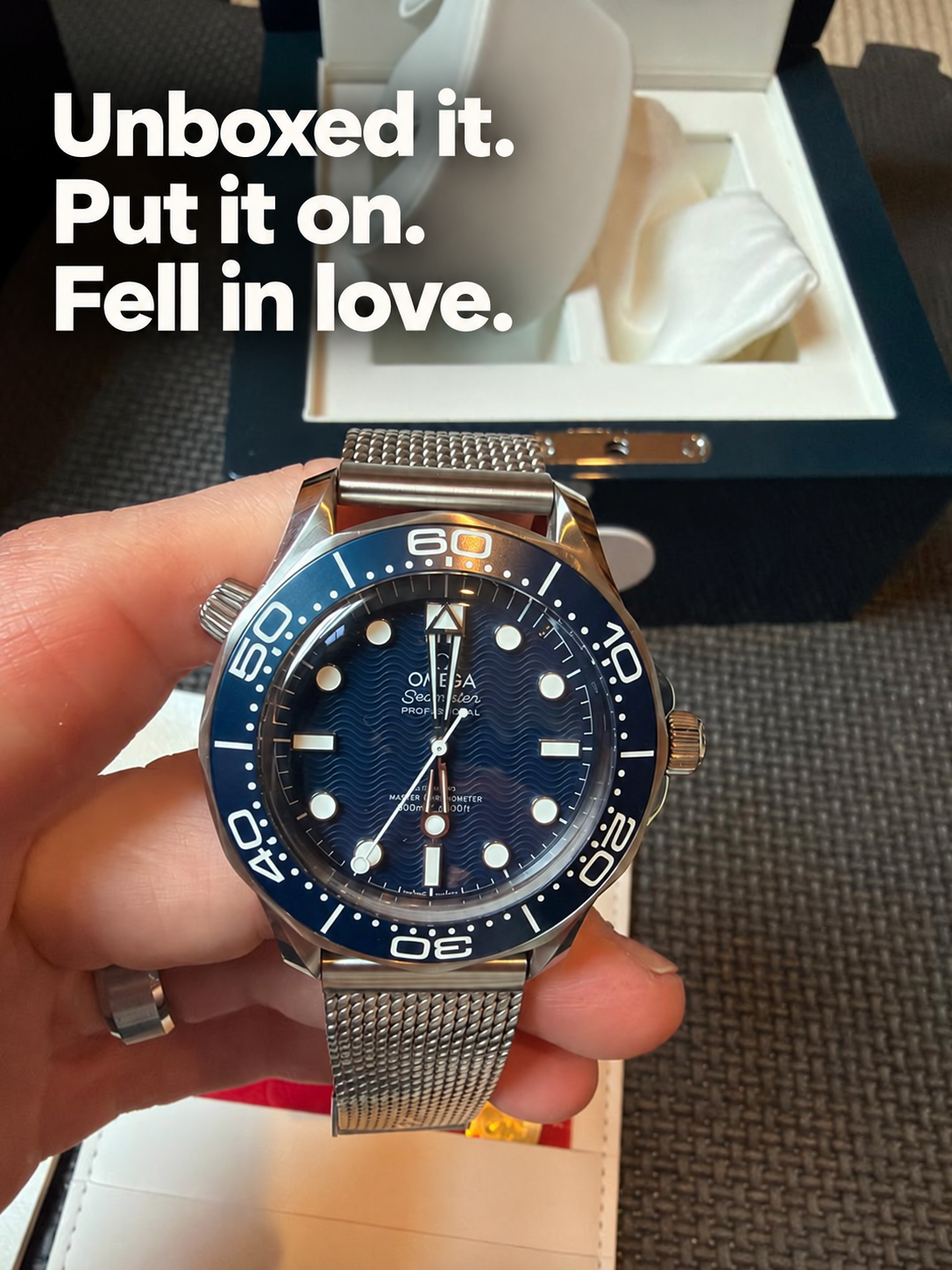 Blue diving watch worn on wrist