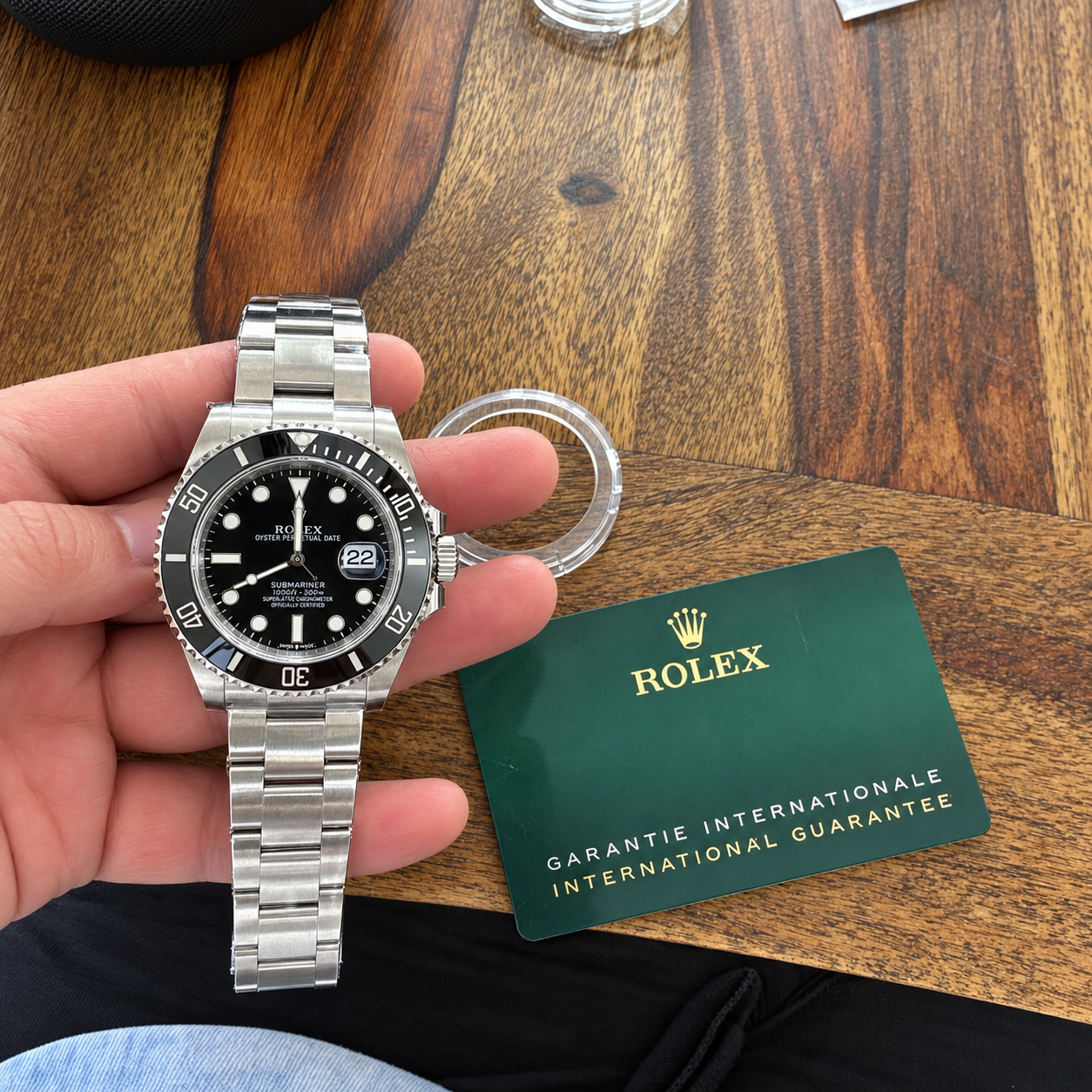 Black-dial Submariner design with a silver-tone link bracelet