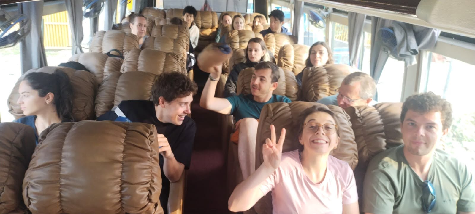Travelers in sofa seats on a World Touch tourist bus