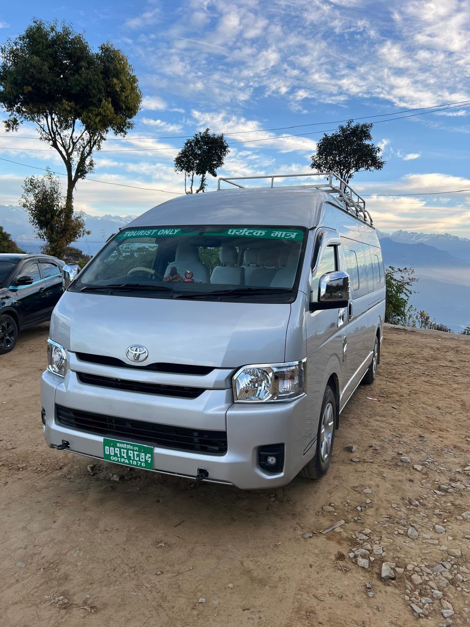 Silver tourist van with driver for group travel in Nepal