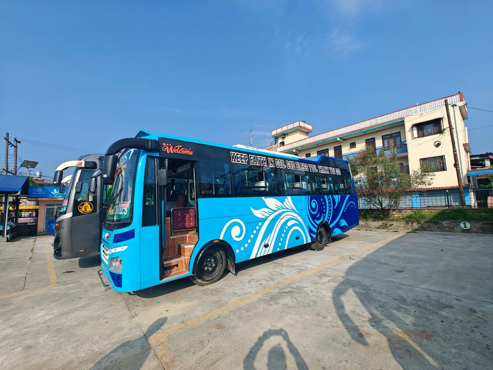 World Touch blue tourist coach at the departure parking area