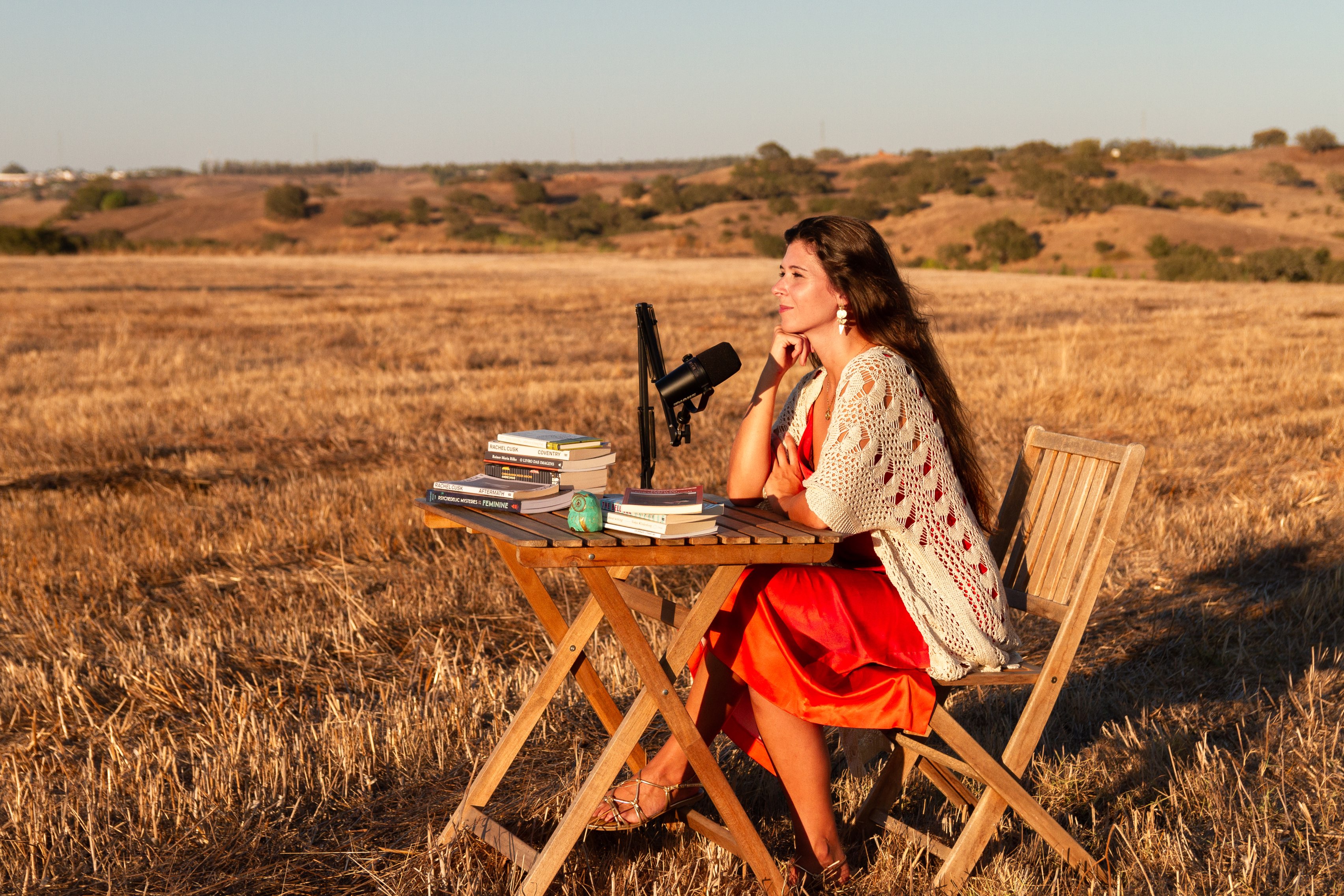 Carlota in field with books