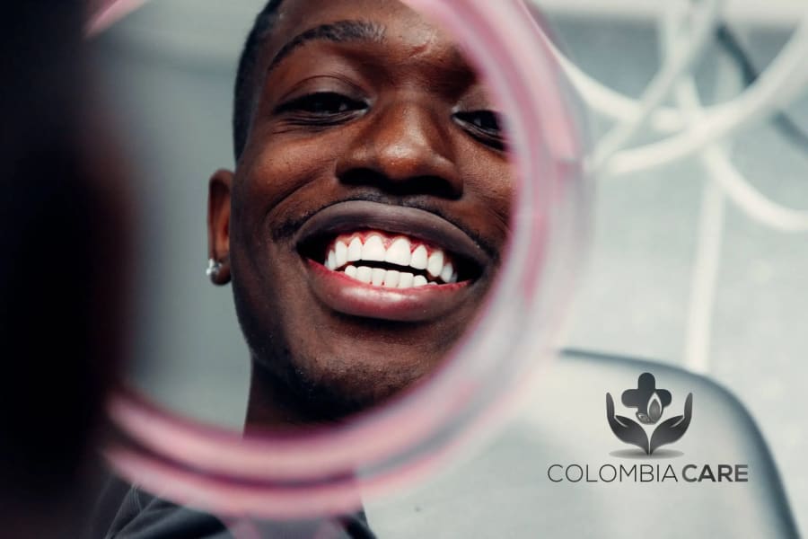 Patient smiling in mirror after dental treatment