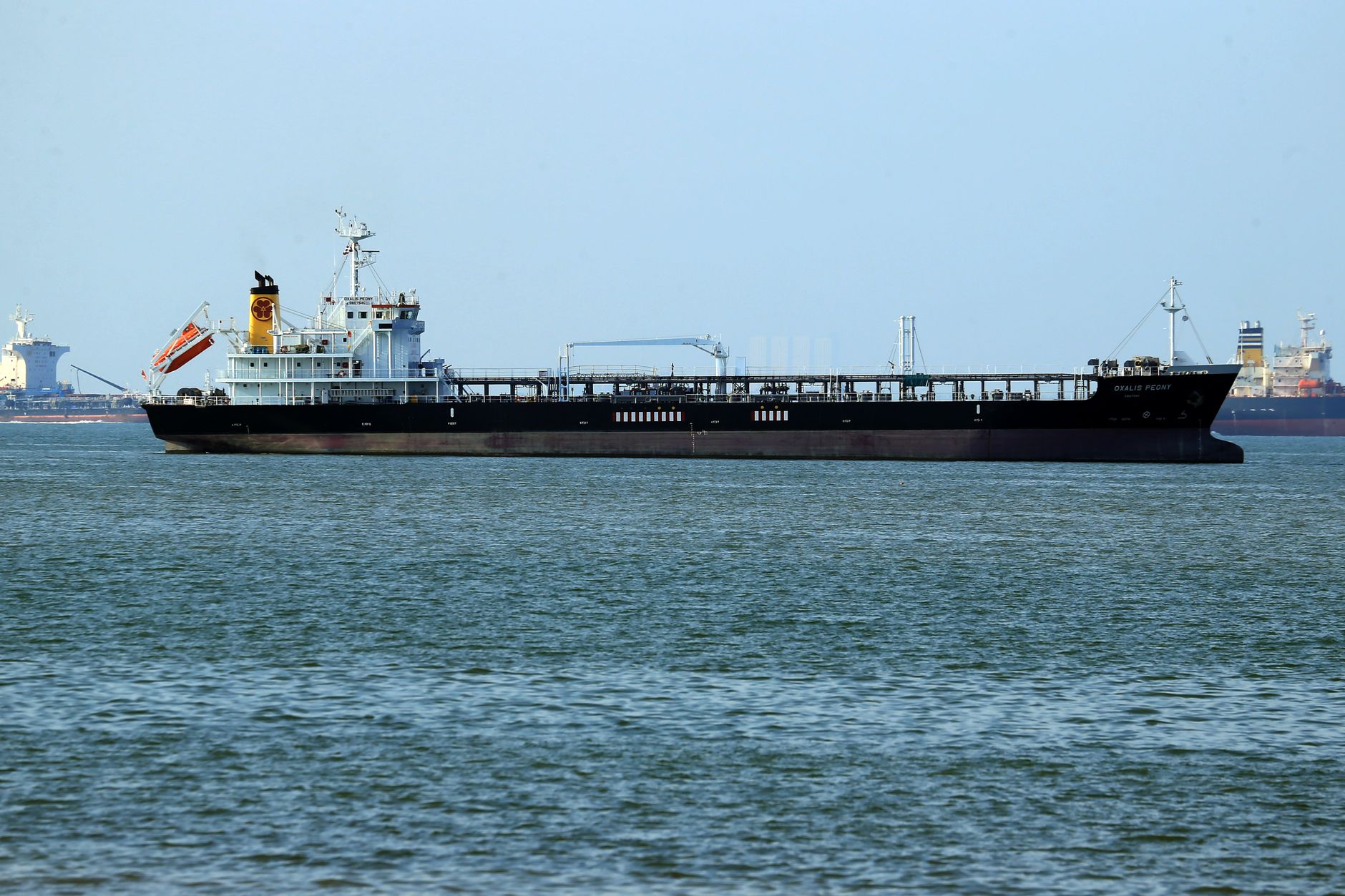 Escalating Tensions: Cargo Ship Struck in Strait of Hormuz Amid Diverging US-Iran Dialogue Claims