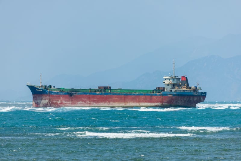 Escalating Tensions: Cargo Ship Struck in Strait of Hormuz Amid Diverging US-Iran Dialogue Claims