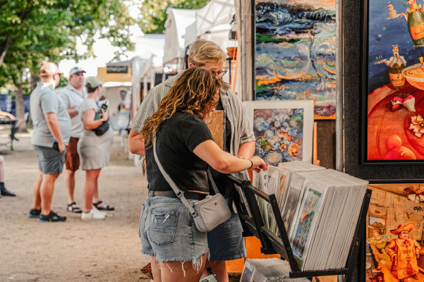 People looking through art prints.