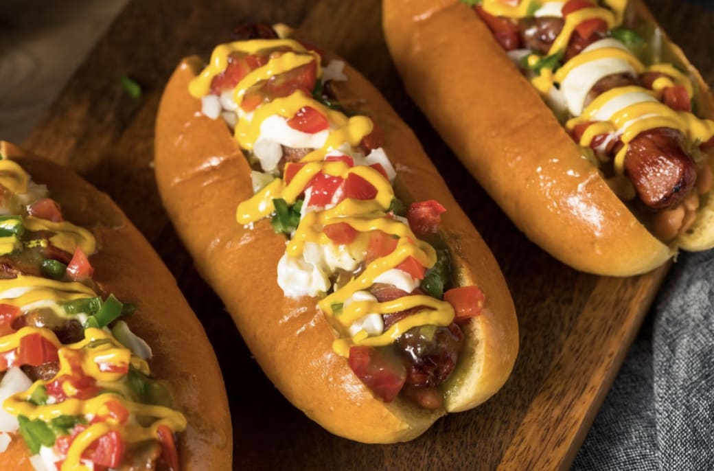 Sonoron hot dogs on a wood board.