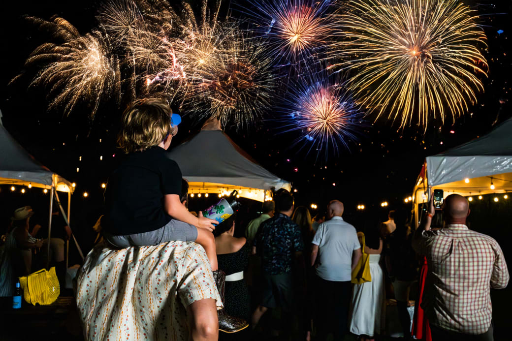 A group of people watching fireworks.