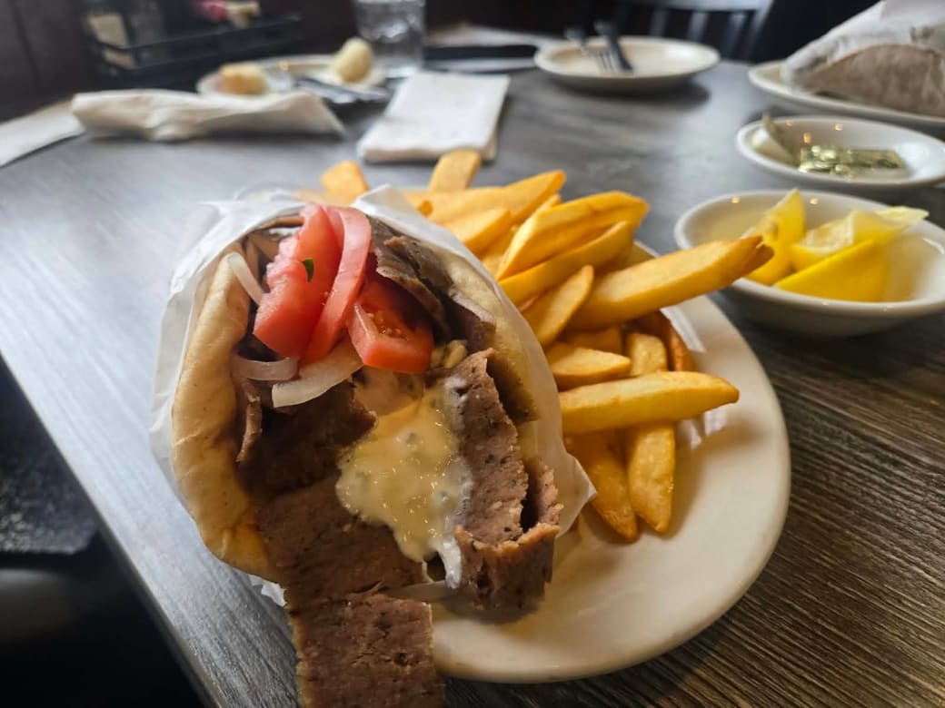 A plate of fries and a gyro.
