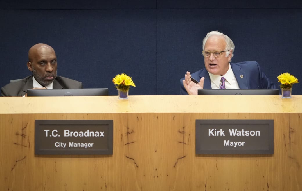 Two men behind a brown podium.