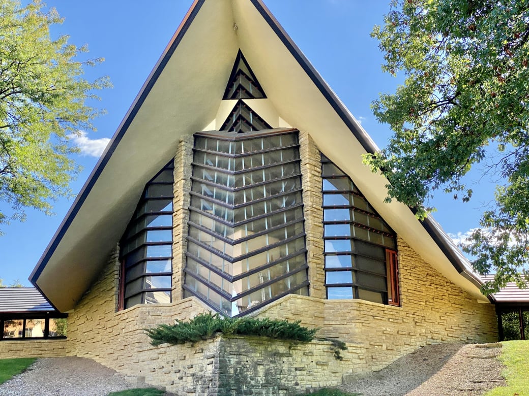 A building with glass windows and a triangular roof.