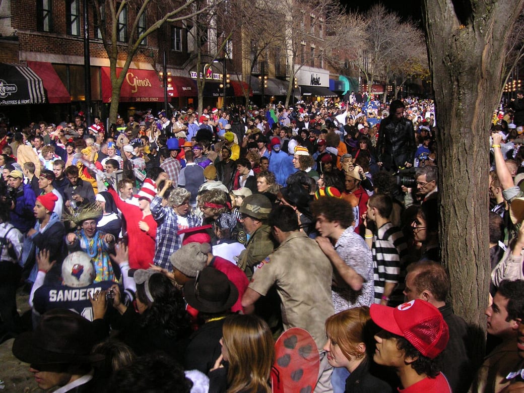 A crowd of people, many in costumes, on a city street.