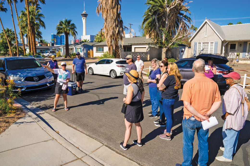 People walking through a neighborhood. 