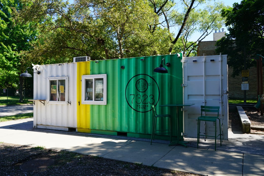 trailer painted white, yellow and green with two windows