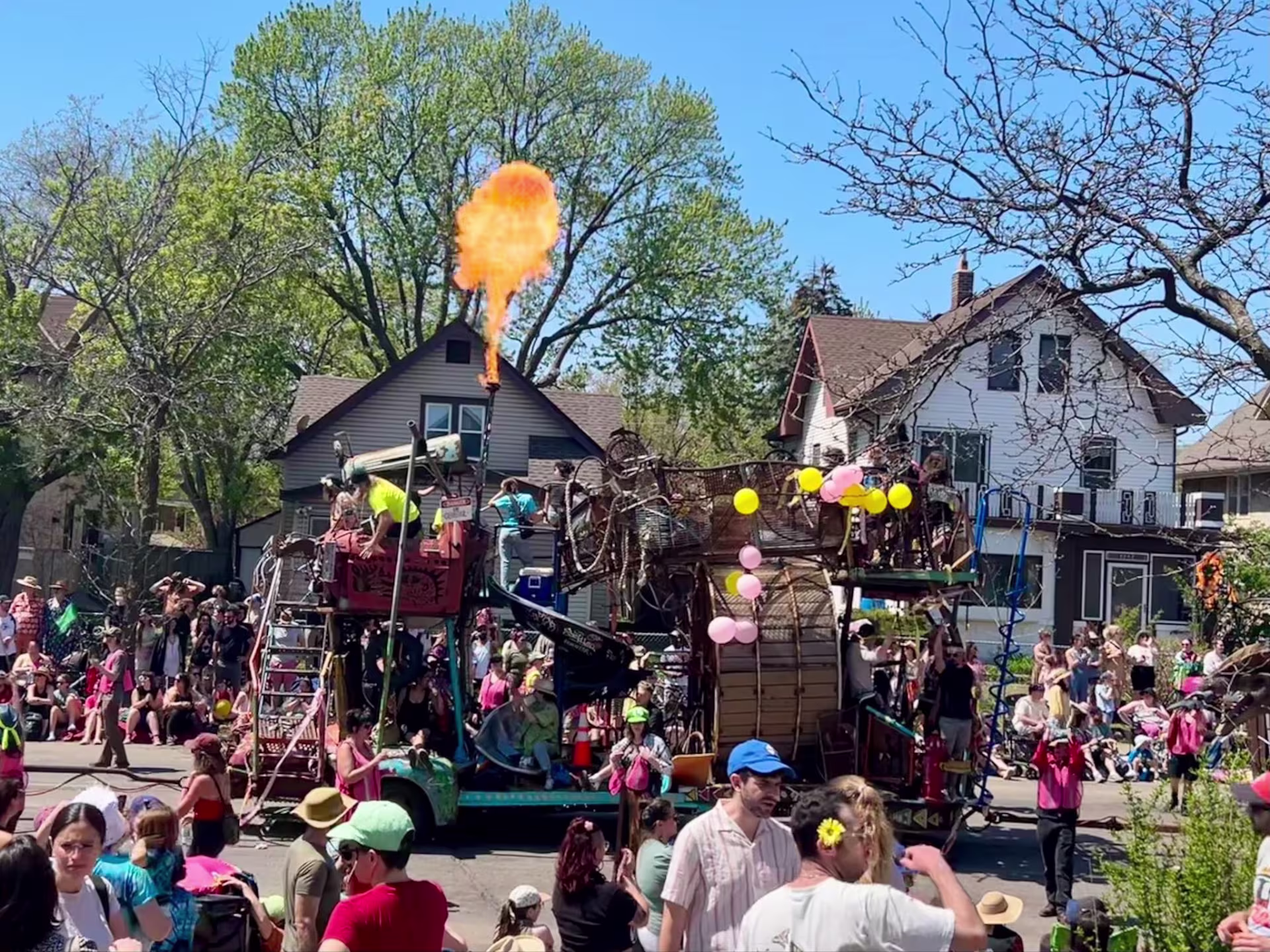 A group of people surrounding a float during a parade
