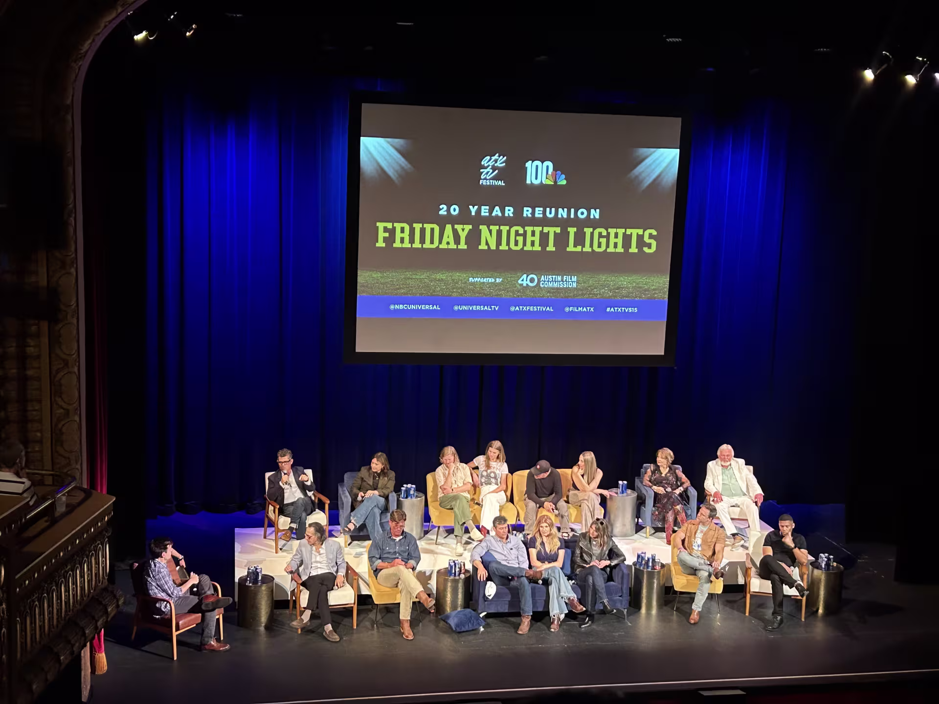 A group of people sitting on a stage.